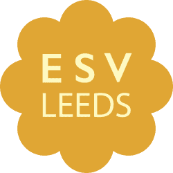 Yellow flower-shaped emblem with ESV LEEDS text in light yellow, representing volunteering group in Leeds for Doing Good Leeds.