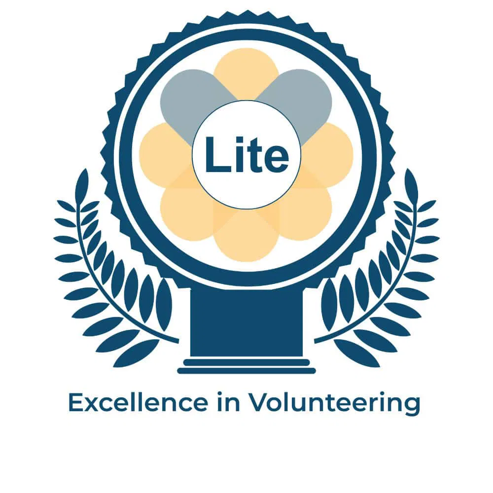 Blue and gold badge with laurel branches and "Lite" in centre, awarded for Excellence in Volunteering by Leeds Volunteering.