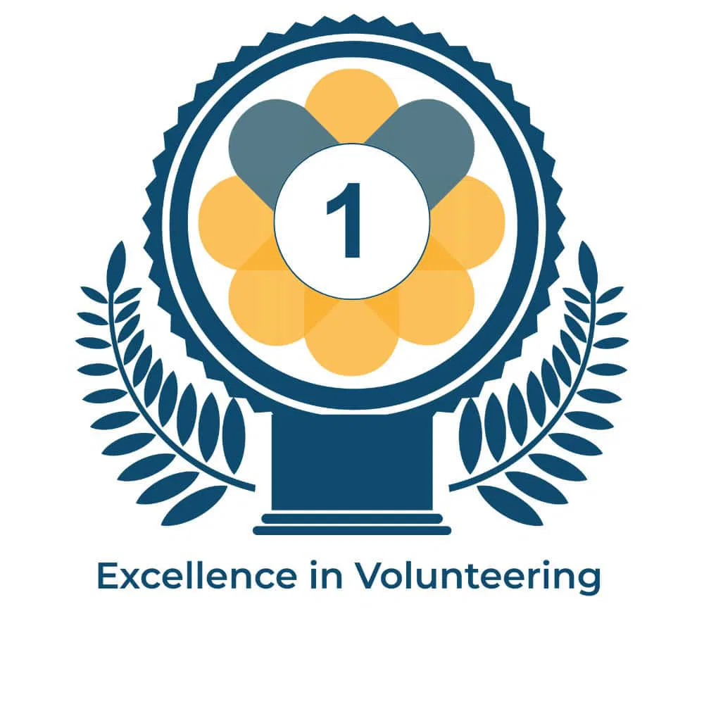 Award badge with flower and laurel design, number 1 centre, Leeds Volunteering Quality Mark: Excellence in Volunteering.
